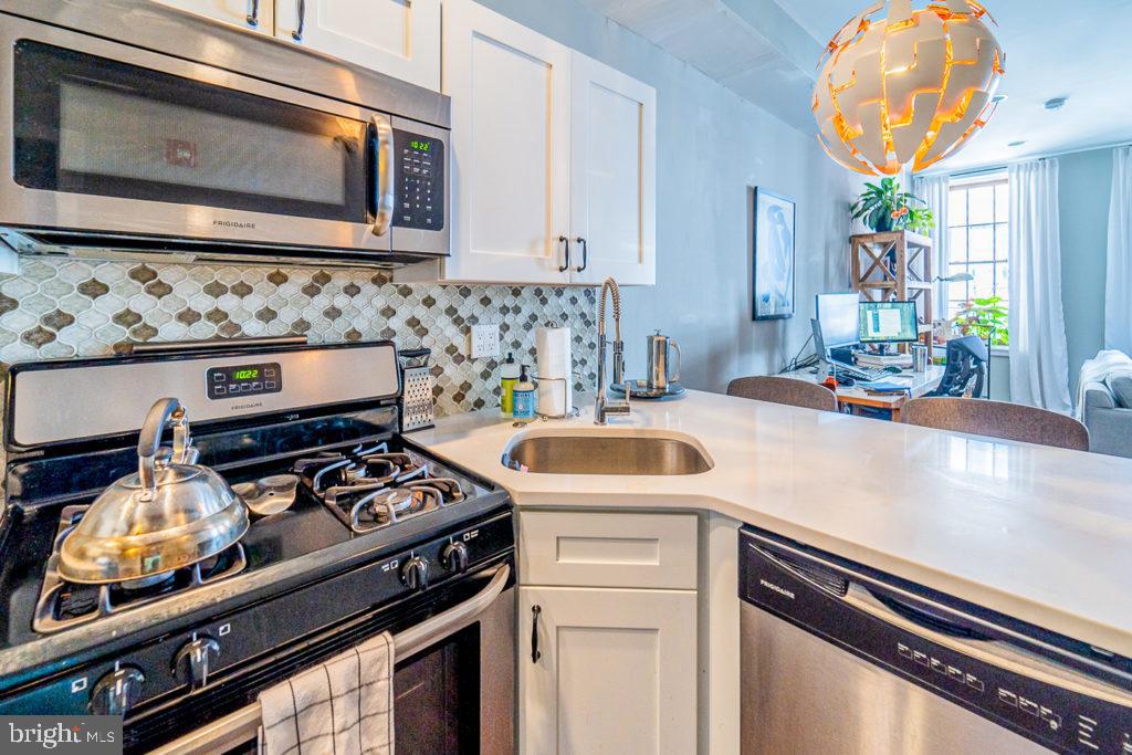19 North 3rd Street Philadelphia, PA 19106 - Photo 5 of 14 a kitchen with a stove a sink and a microwave