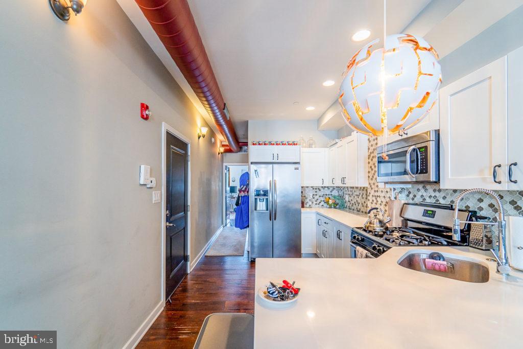 19 North 3rd Street Philadelphia, PA 19106 - Photo 8 of 14 a room with lots of wooden furniture and a chandelier