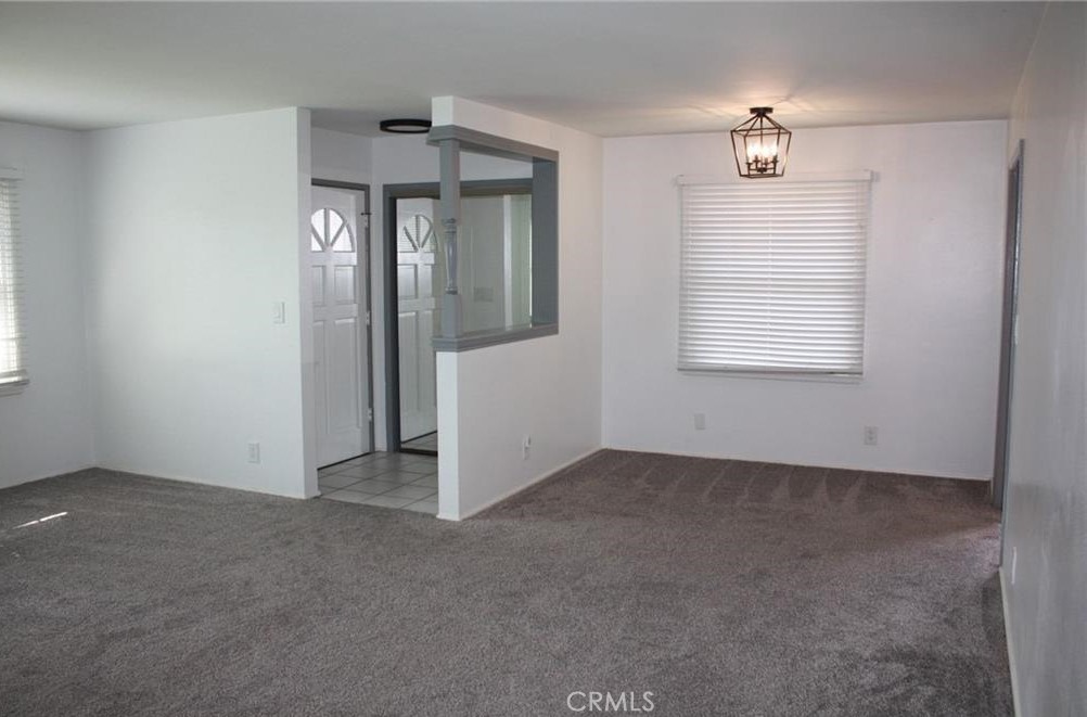 3585 Timothy Way Riverside, CA 92506 - Photo 5 of 14 an empty room with chandelier fan and windows