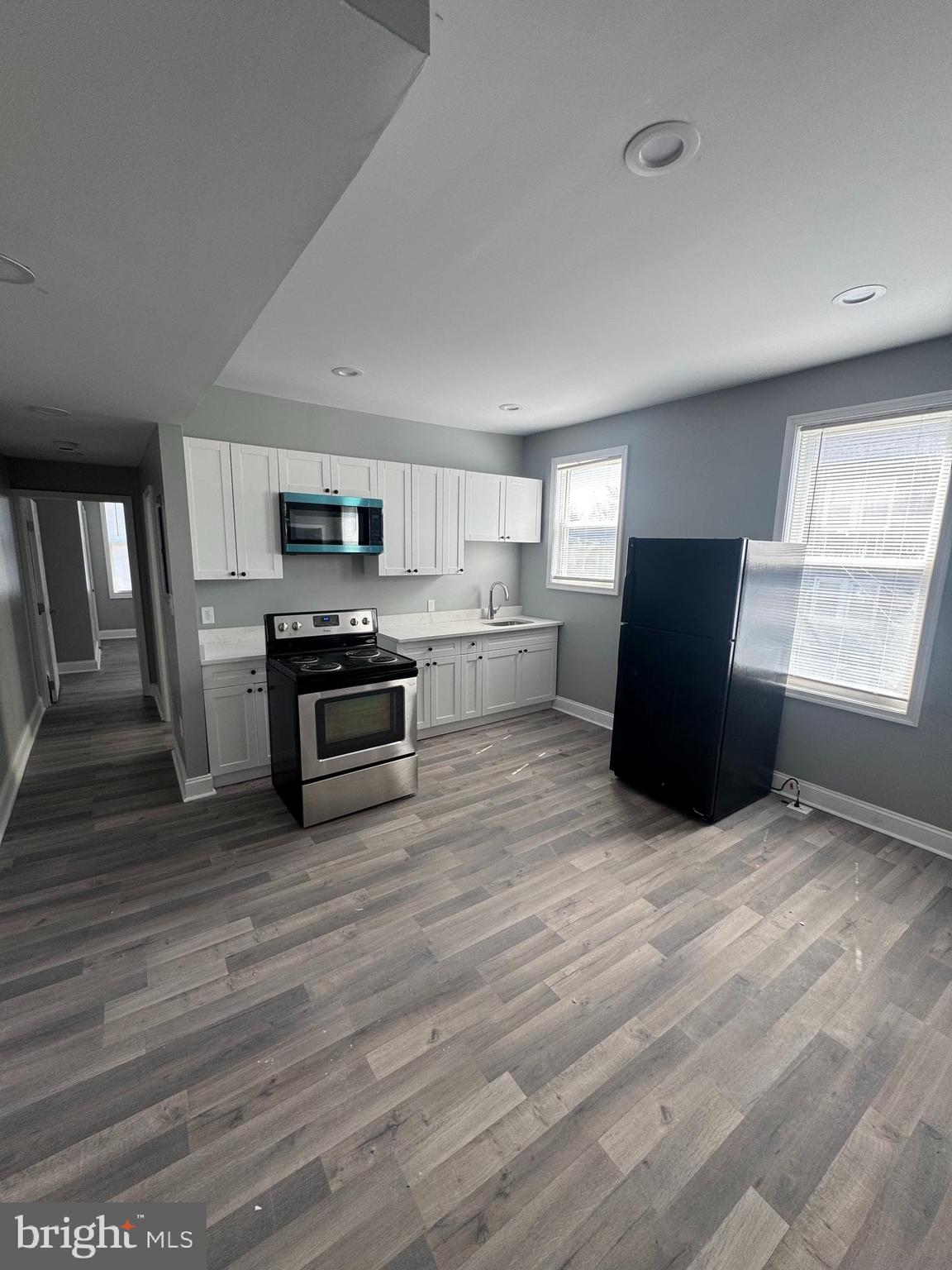4303 York Road Baltimore, MD 21212 - Photo 5 of 21 a kitchen with granite countertop a refrigerator and a stove top oven