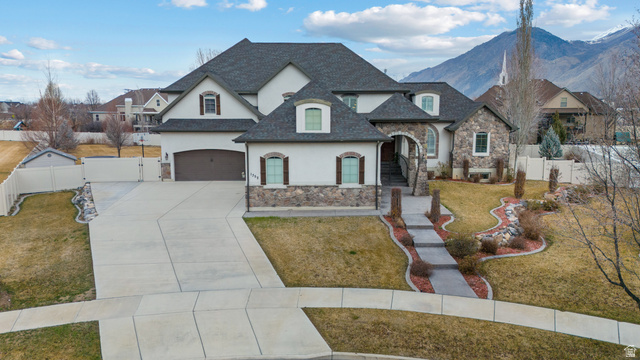 1352 West 900 South Mapleton, UT 84664 - Photo 1 of 1 French country style house with stone siding, a gate, stucco siding, driveway, and a garage