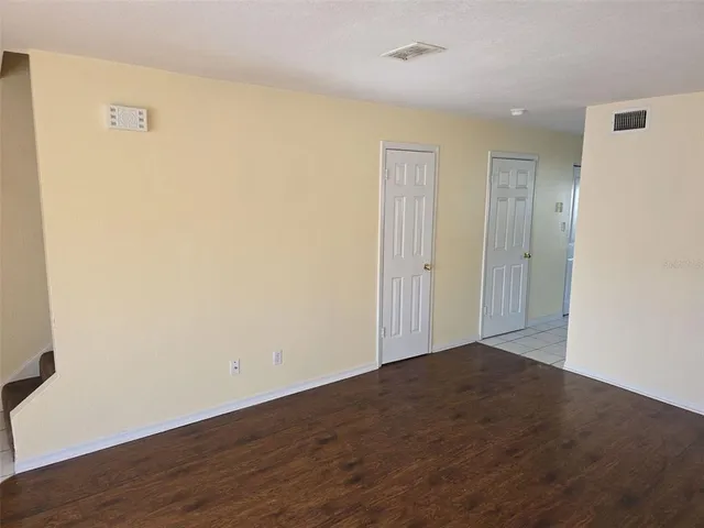 an empty room with wooden floor