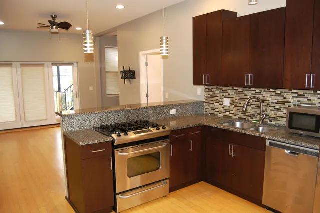 a kitchen with granite countertop a stove and a sink