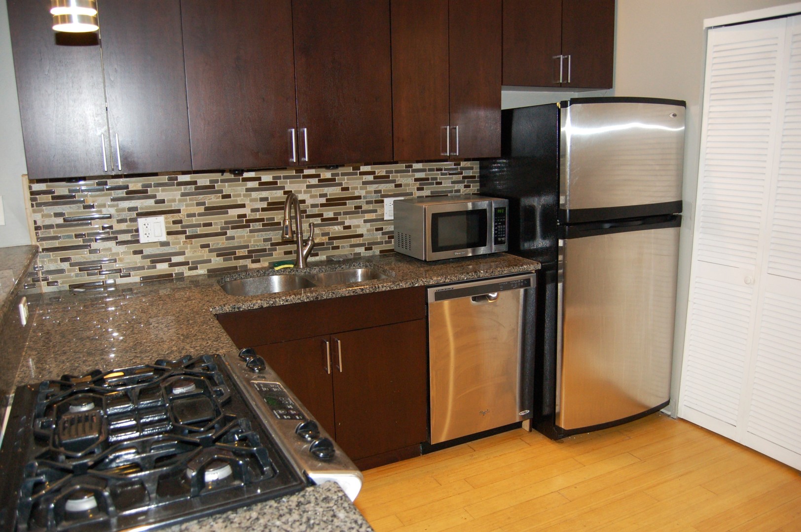 2649 West Haddon Avenue, Unit 2S Chicago, IL 60622 - Photo 5 of 14 a kitchen with stainless steel appliances granite countertop a stove a refrigerator and a oven