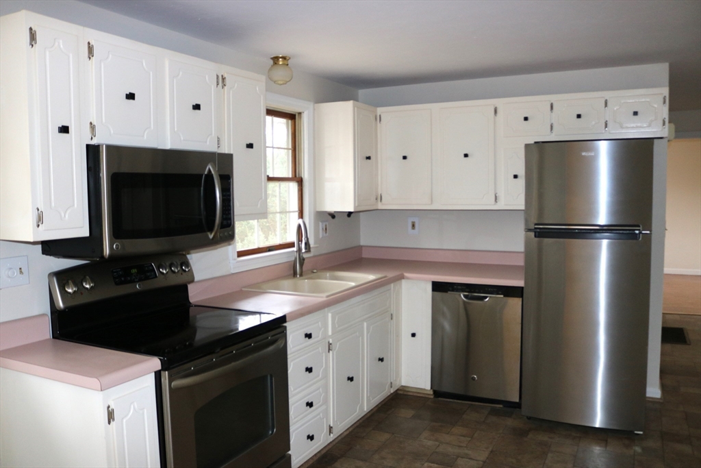 28 Chevy Chase Road Worcester, MA 01606 - Photo 4 of 17 a kitchen with stainless steel appliances white cabinets sink and a refrigerator
