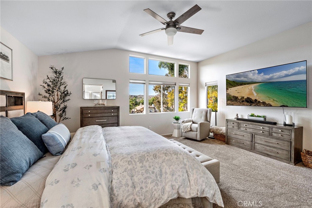 2004 Via Solona San Clemente, CA 92673 - Photo 14 of 20 a spacious bedroom with a bed a couch and a flat screen tv