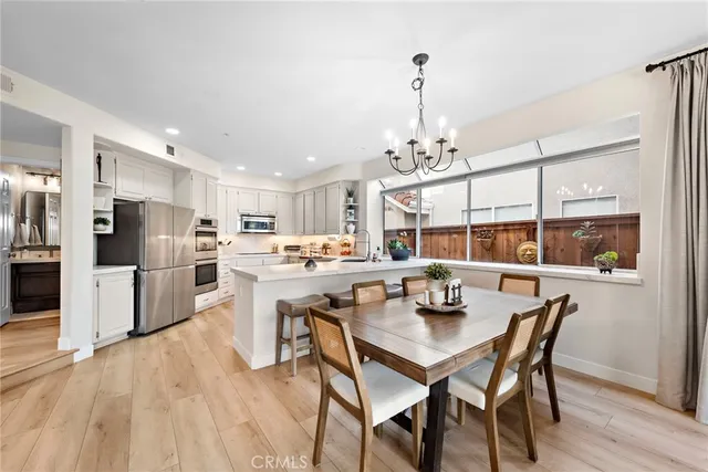 a kitchen with cabinets appliances a sink and a window