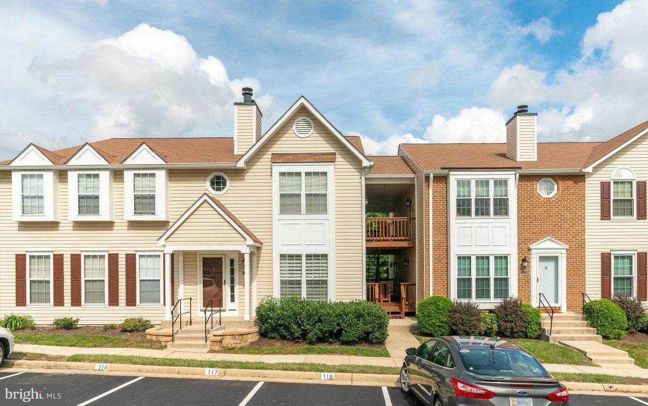7702 Lexton Place, Unit 65 Springfield, VA 22152 - Photo 1 of 24 a front view of a residential houses with yard
