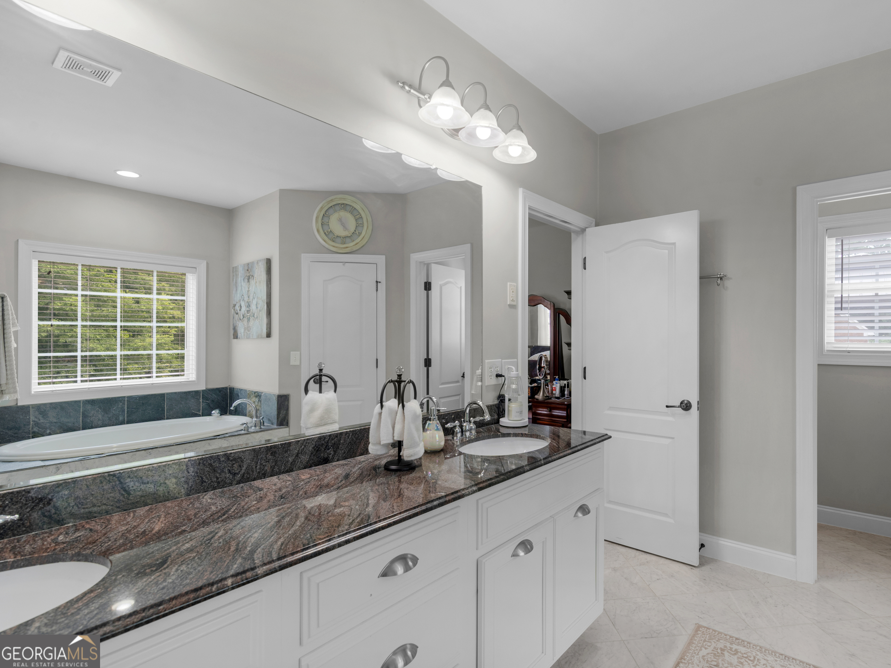 221 Hummingbird Court Hampton, GA 30228 - Photo 47 of 77 a bathroom with a sink double vanity granite and a mirror