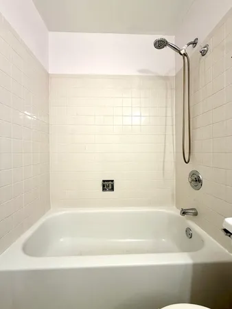 a bathroom with a bathtub and shower