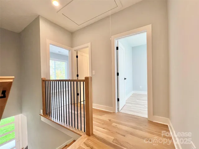 a view of a hallway with a door and a window