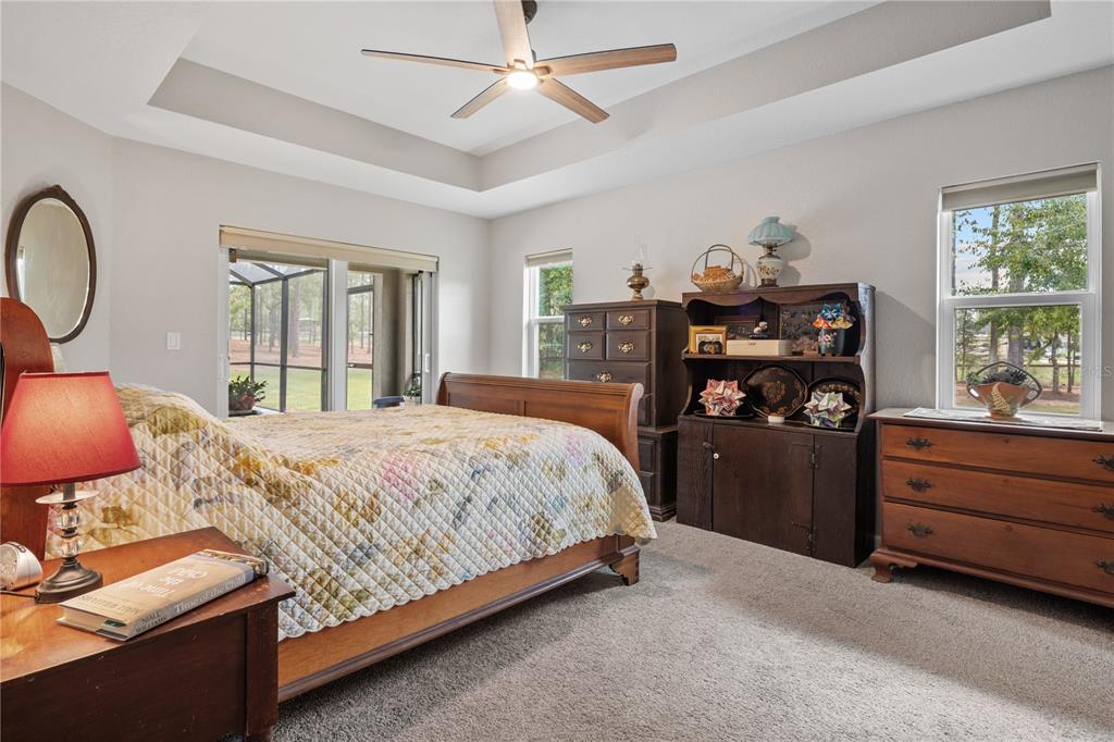 12929 Southwest 89th Street Dunnellon, FL 34432 - Photo 21 of 76 a bedroom with a bed and wooden floor