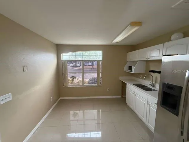 a kitchen with stainless steel appliances a refrigerator and a stove