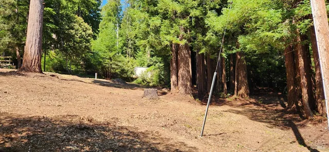 a wooden fence with trees in the background