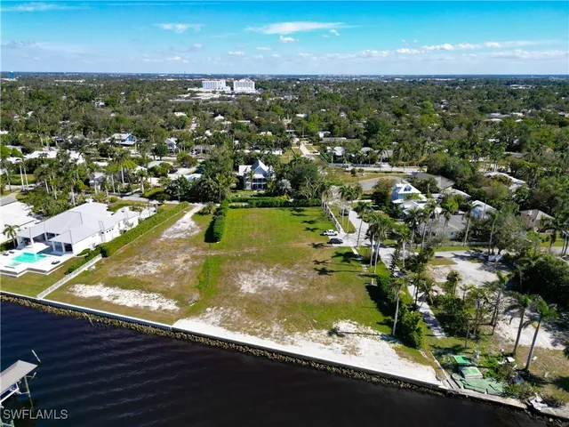 an aerial view of residential houses with outdoor space and river