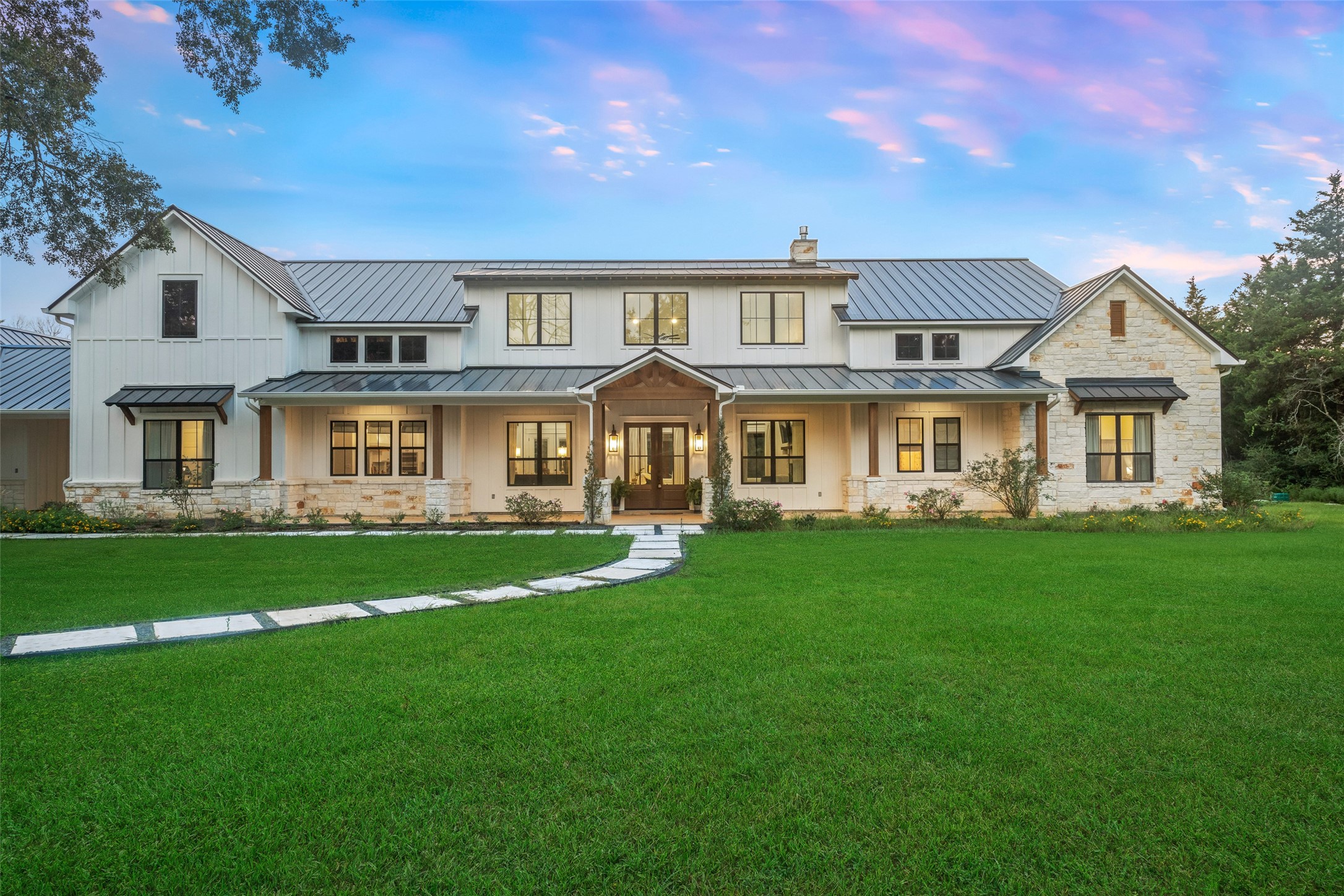 a front view of a house with a garden