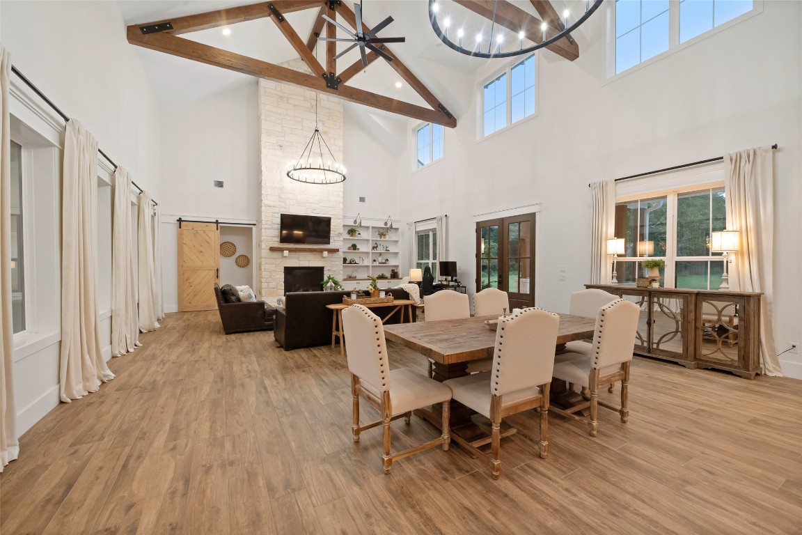 27201 Double Culvert Road Hempstead, TX 77445 - Photo 14 of 49 Dining space sits beneath wood beams and oversized windows, offering an open and inviting gathering area.