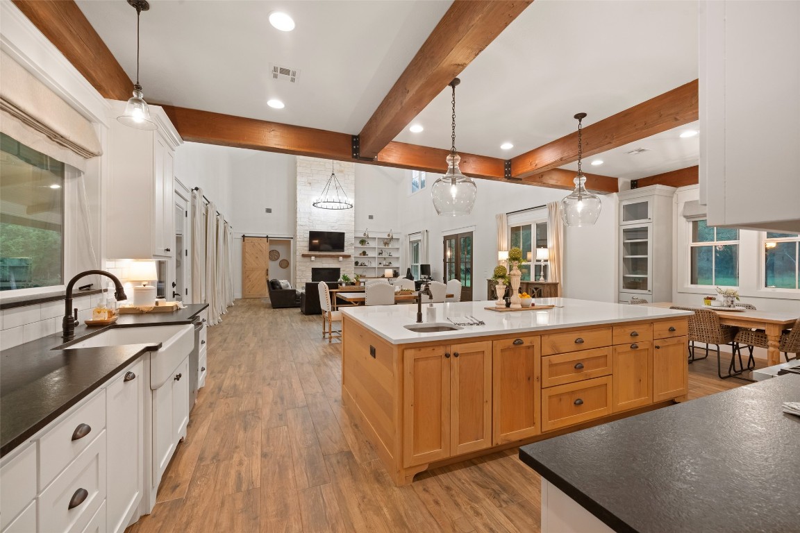 27201 Double Culvert Road Hempstead, TX 77445 - Photo 18 of 49 Expansive kitchen view showcases dual-tone counters, a large quartz island with prep sink, and seamless connection to the living and dining areas.
