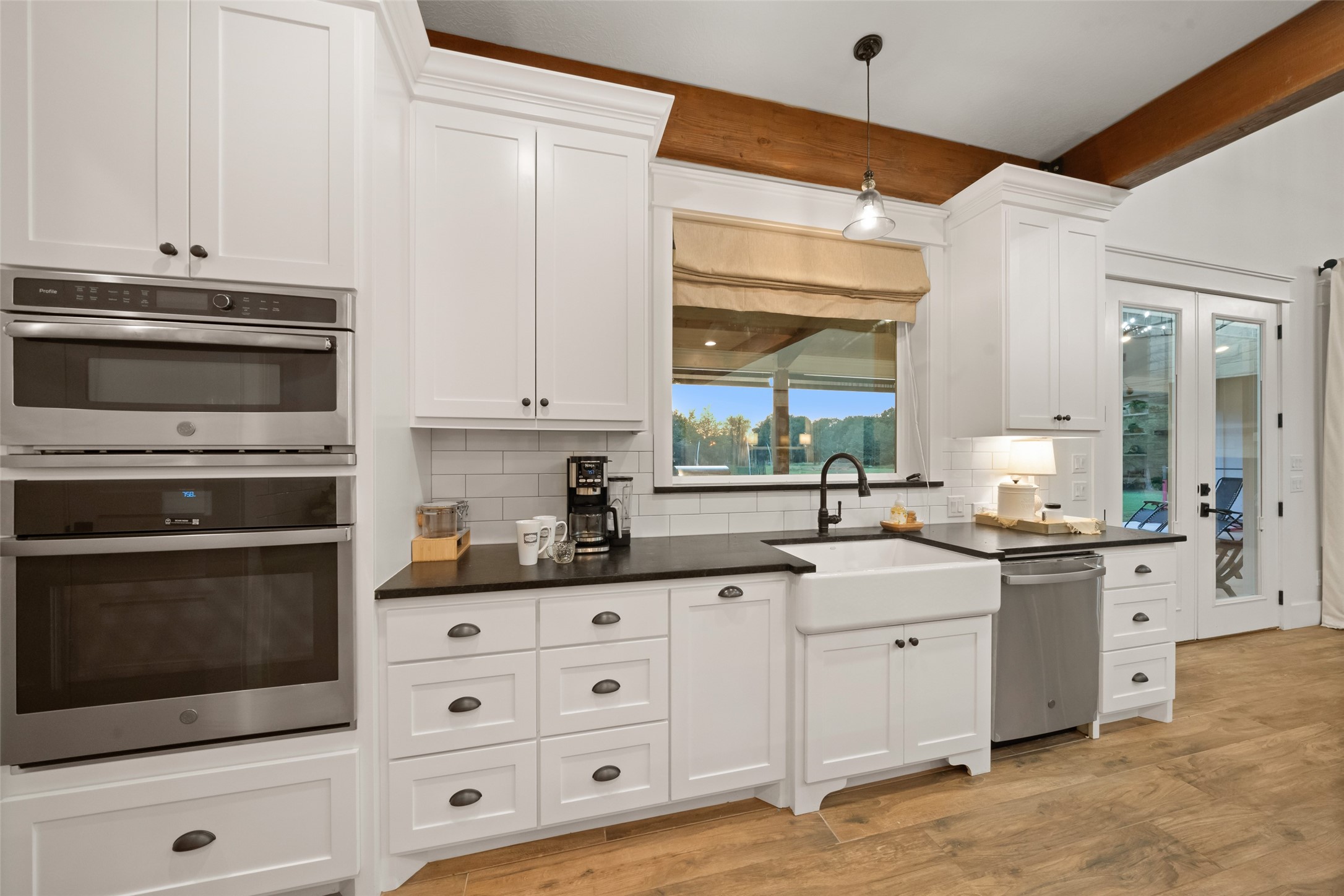 27201 Double Culvert Road Hempstead, TX 77445 - Photo 21 of 48 a kitchen with granite countertop a sink cabinets and stainless steel appliances
