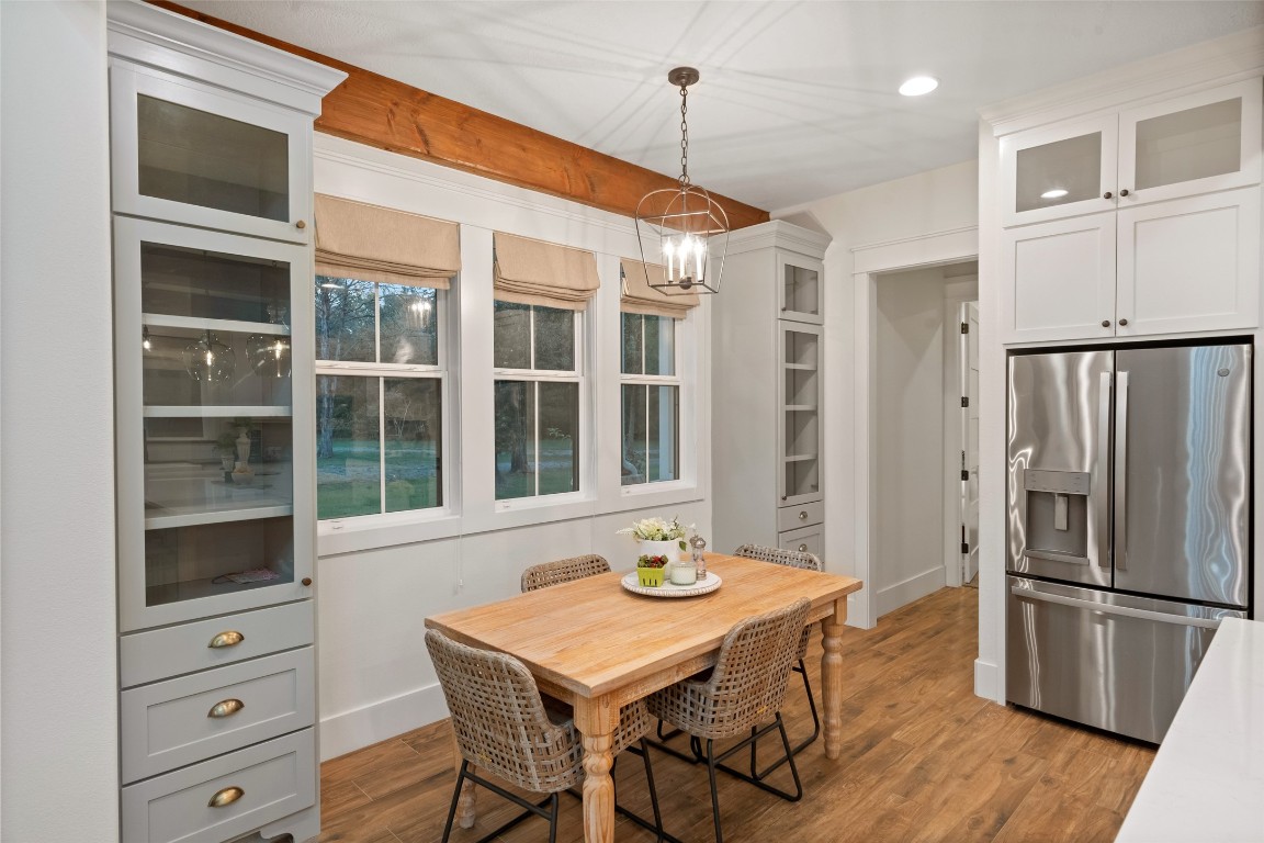 27201 Double Culvert Road Hempstead, TX 77445 - Photo 23 of 49 Charming breakfast nook framed by picture windows, flanked by built-in cabinetry with glass fronts for display.