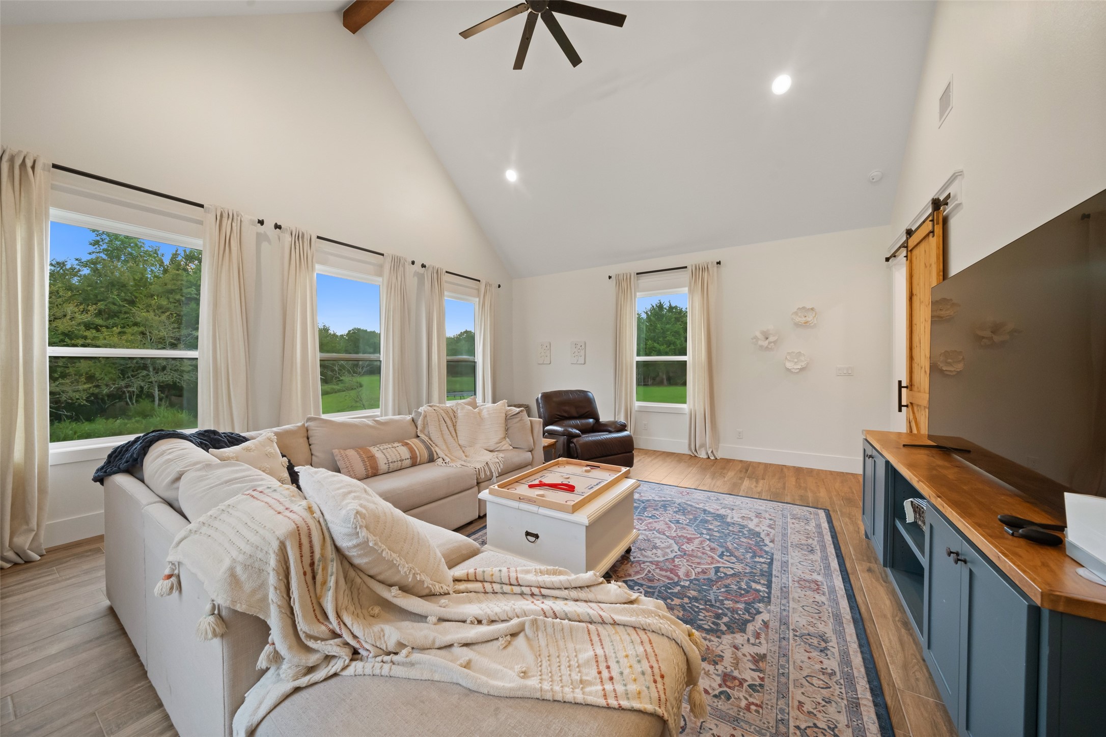 27201 Double Culvert Road Hempstead, TX 77445 - Photo 24 of 48 a living room with furniture a large window and a flat screen tv