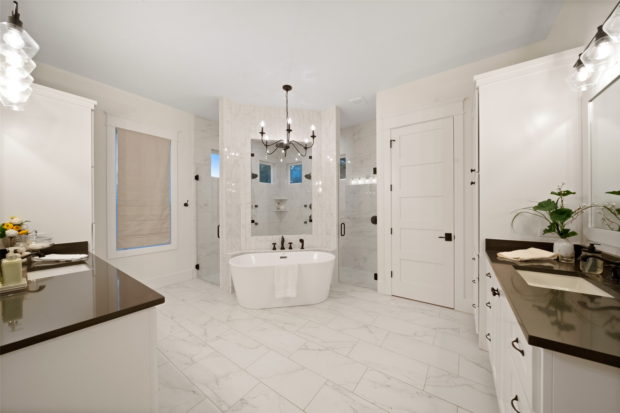 27201 Double Culvert Road Hempstead, TX 77445 - Photo 31 of 49 Primary bathroom showcasing a freestanding soaking tub, dual-entry walk-in shower, and chandelier detail for a spa-like feel.