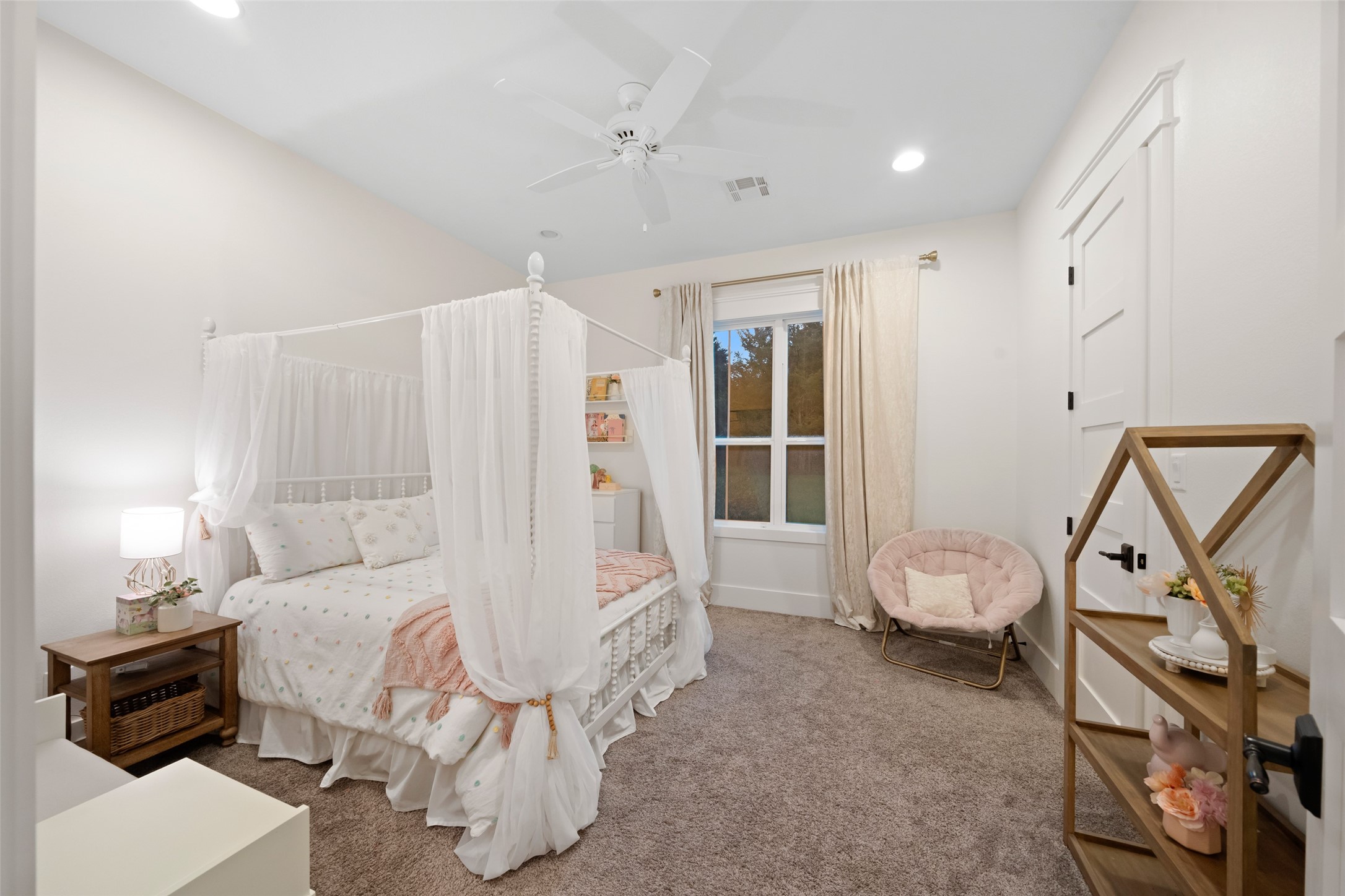 27201 Double Culvert Road Hempstead, TX 77445 - Photo 37 of 49 Charming bedroom with canopy bed, plush carpeting, and a soft neutral palette accented by natural light from a large window.