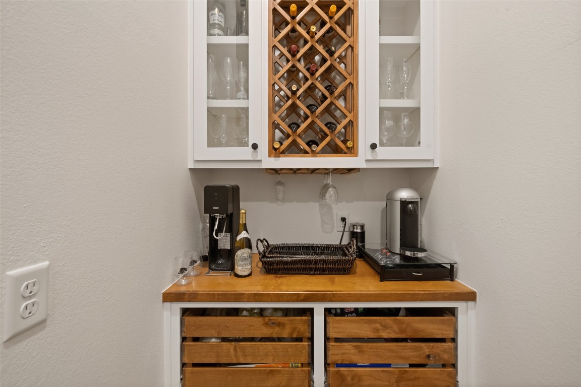 27201 Double Culvert Road Hempstead, TX 77445 - Photo 7 of 49 Custom beverage station with built-in wine storage, glass-front cabinetry, and butcher block counters adds function and flair.