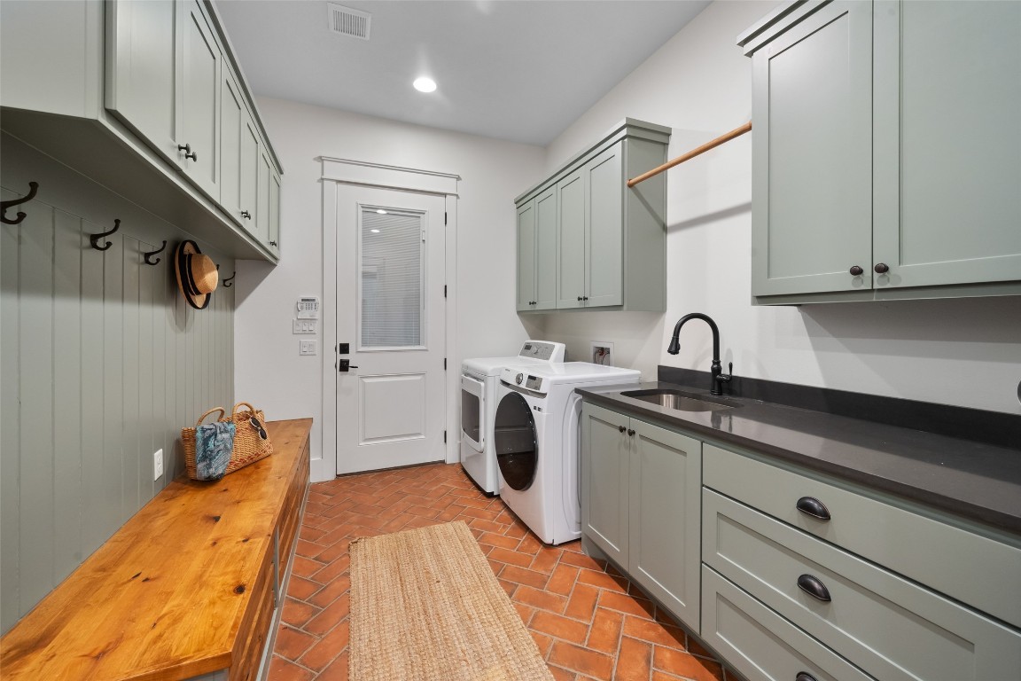 27201 Double Culvert Road Hempstead, TX 77445 - Photo 9 of 49 Utility room with brick flooring features a deep sink, abundant cabinetry, and space for both refrigerator and freezer.