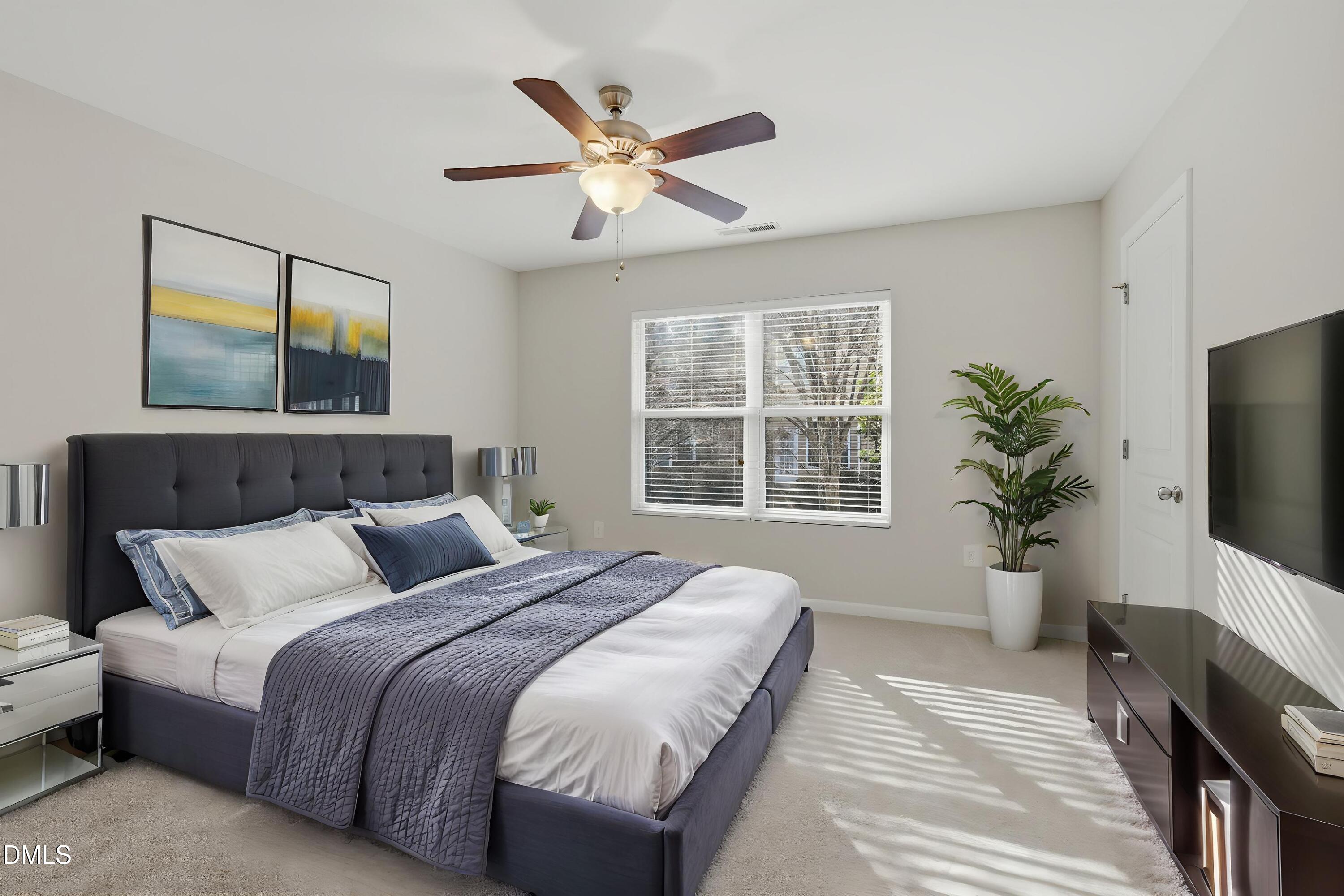 2907 Berkeley Springs Place Raleigh, NC 27616 - Photo 5 of 34 a bedroom with a bed and a potted plant