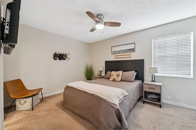 a bedroom with a large bed and a chair