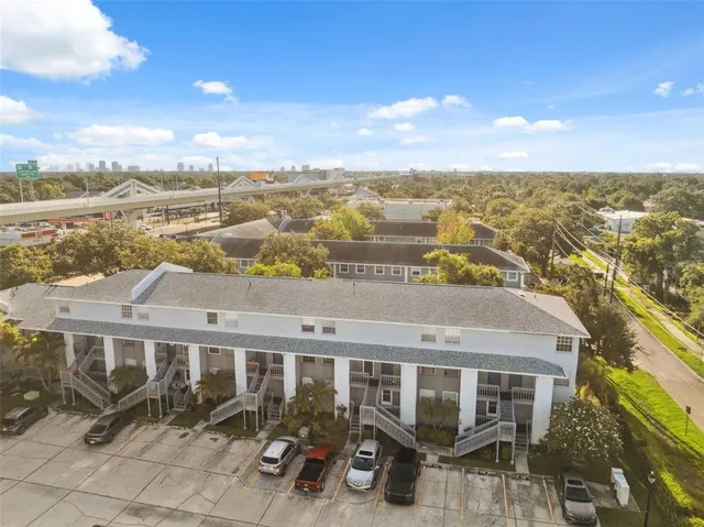 an aerial view of residential houses with outdoor space and ocean view
