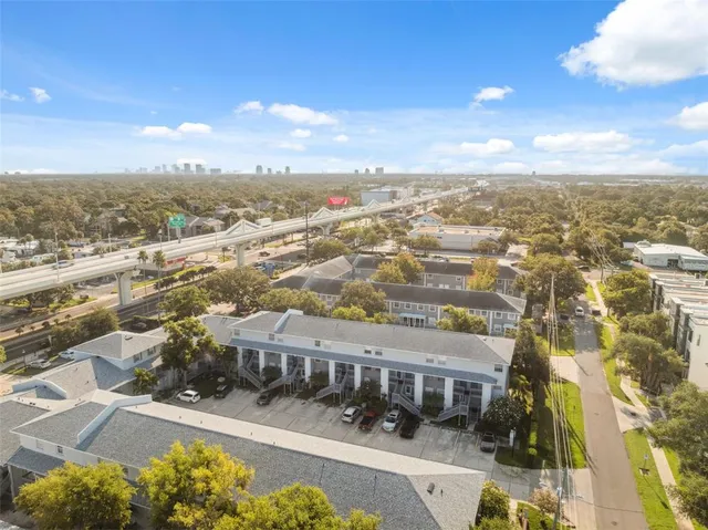 an aerial view of residential houses with city view