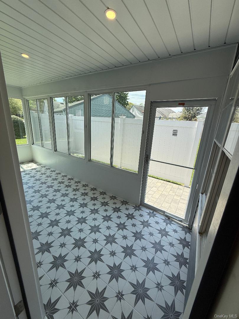 379 Larchmont Court Ridge, NY 11961 - Photo 7 of 17 a view of an empty room and window