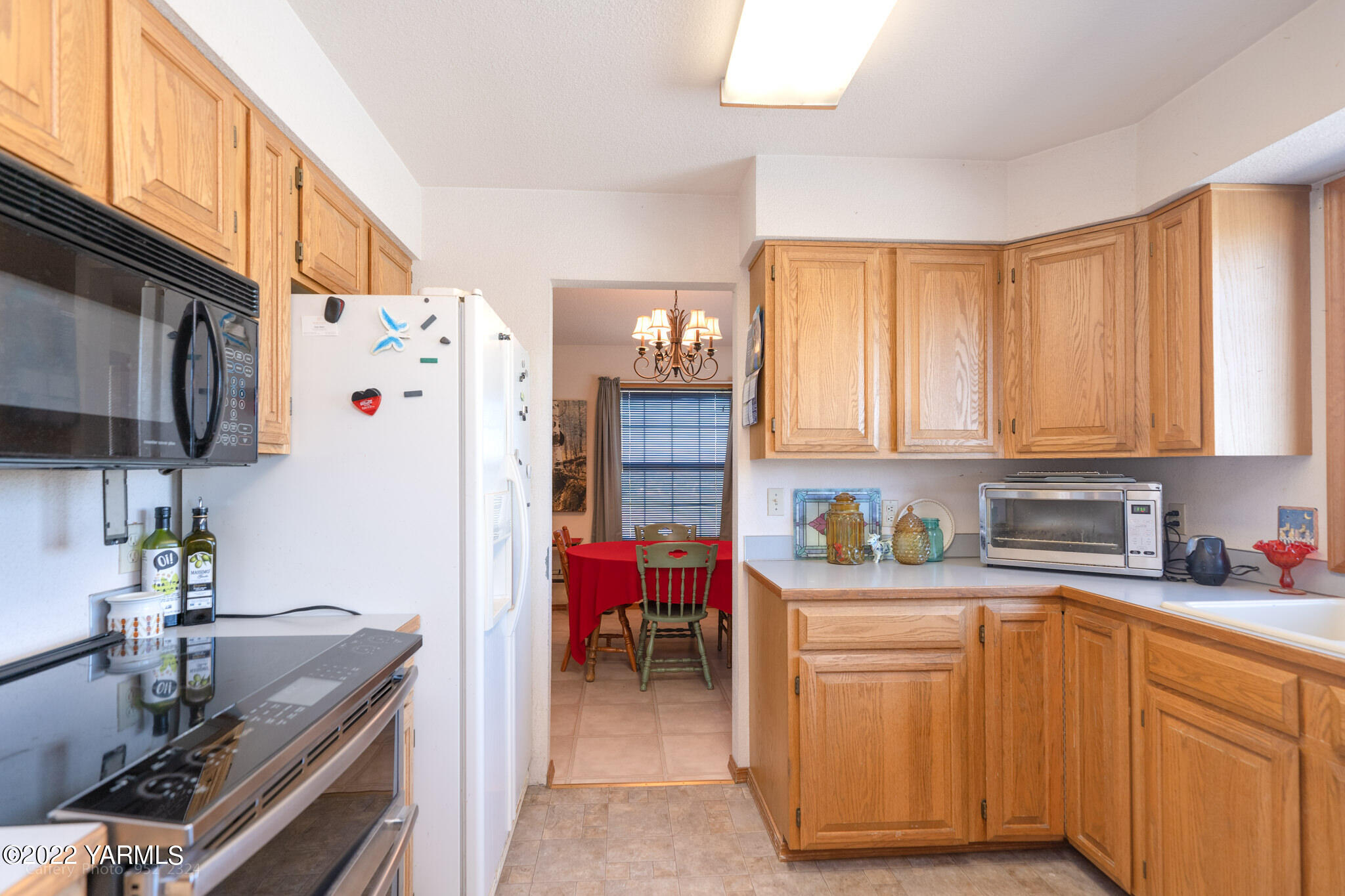 3870 Aaron Road Moxee, WA 98936 - Photo 7 of 33 a kitchen with stainless steel appliances granite countertop a sink stove and refrigerator