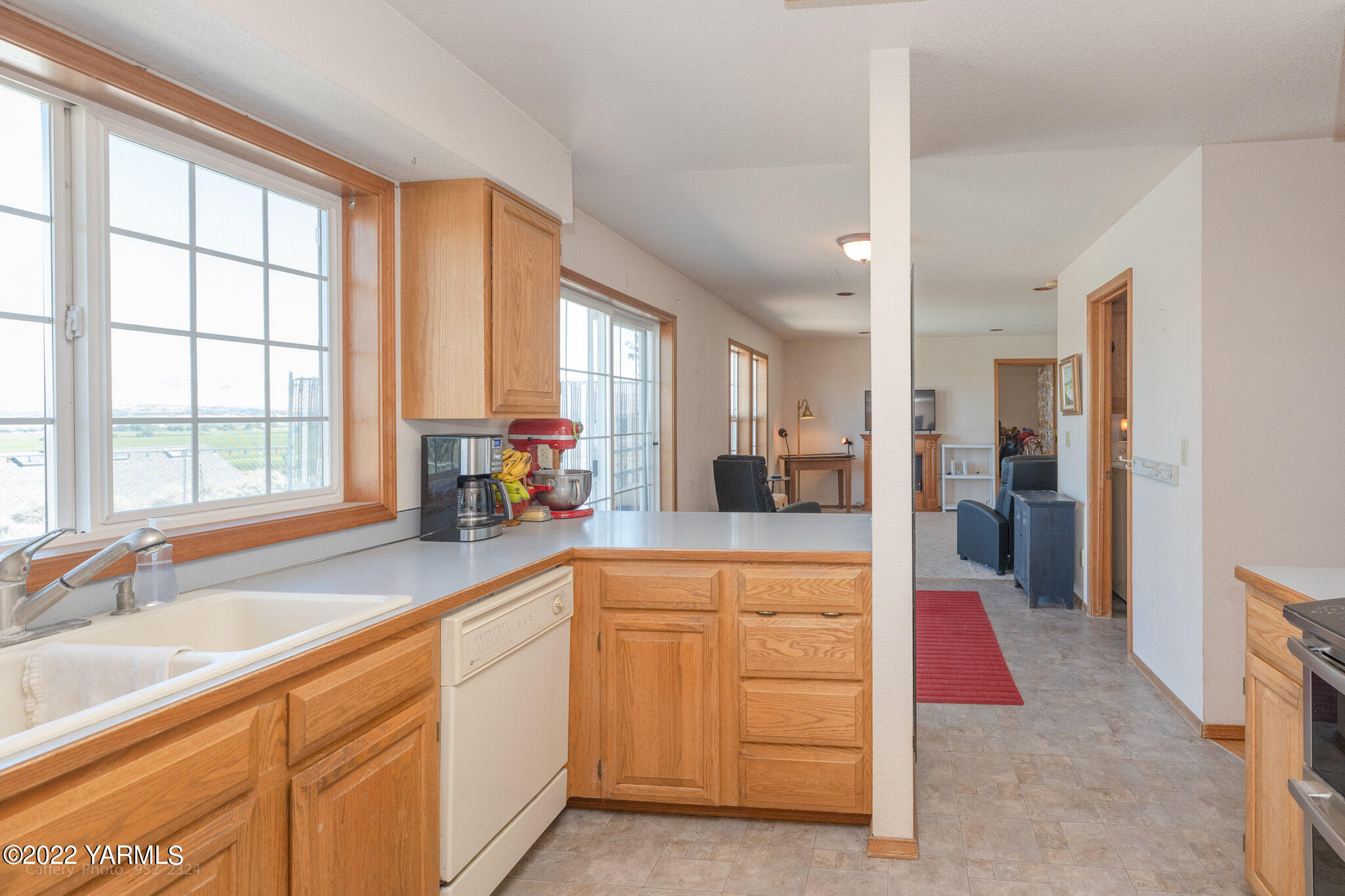 3870 Aaron Road Moxee, WA 98936 - Photo 9 of 33 a large kitchen with kitchen island granite countertop a large window