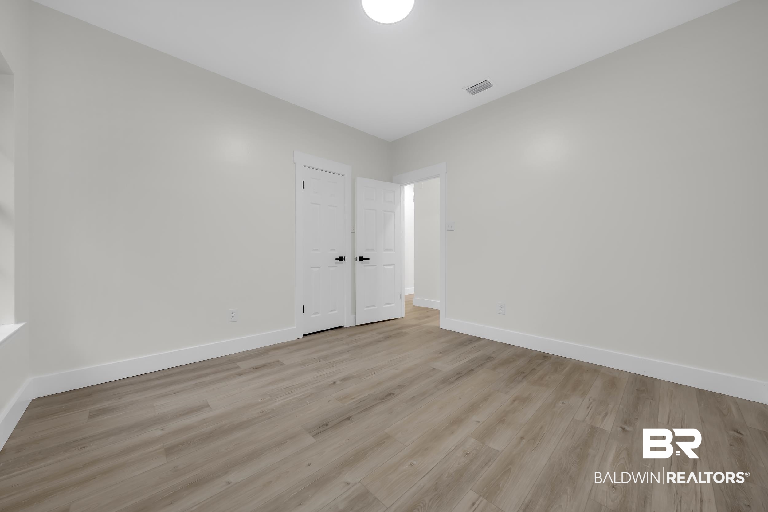 4924 Brooke Court Mobile, AL 36618 - Photo 25 of 34 Unfurnished bedroom with light wood-style floors and baseboards