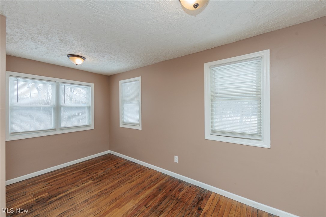 5062 Lee Road Maple Heights, OH 44137 - Photo 23 of 50 Spare room featuring a textured ceiling and hardwood / wood-style flooring