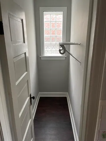 a view of a room with wooden floor and white walls