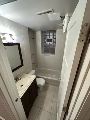 a bathroom with a sink a toilet a mirror and shower
