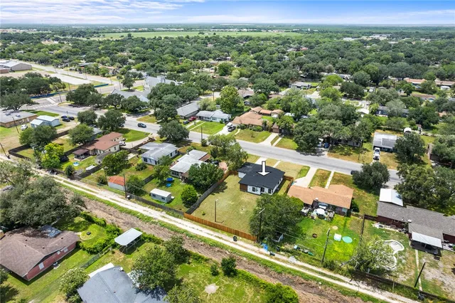 an aerial view of residential houses with outdoor space and street view