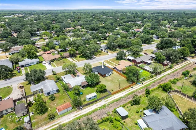 an aerial view of residential houses with outdoor space