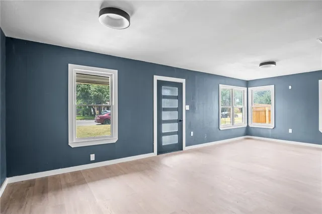 a view of a bedroom with a bed and a window