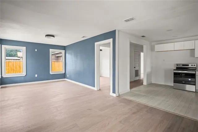 a view of empty room with a window and fireplace