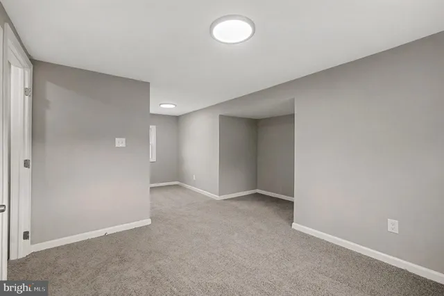 a view of an empty room with a bathroom