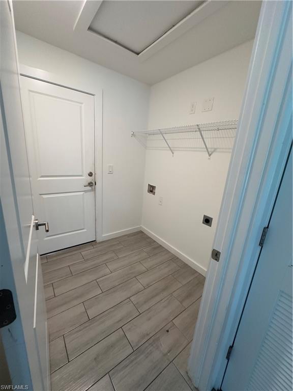 3707 38th Street Southwest Lehigh Acres, FL 33976 - Photo 14 of 16 Laundry area with wood finish floors and washer hookup