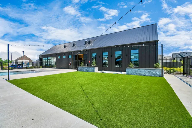 a swimming pool with outdoor seating and yard