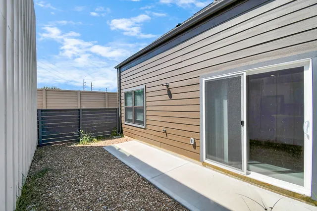 a backyard of a house with table and chairs