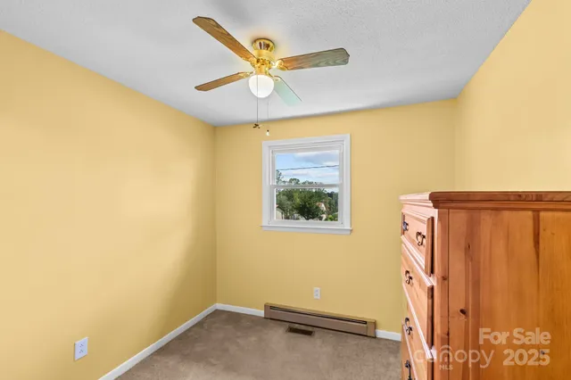 a view of a hallway with a ceiling fan