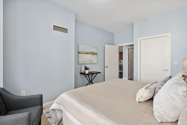 a bedroom with a bed and a chair